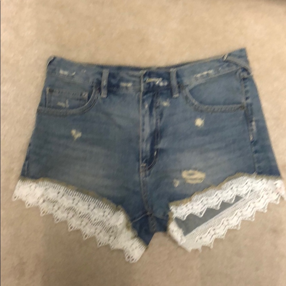 Free People distressed denim shorts with lace trim